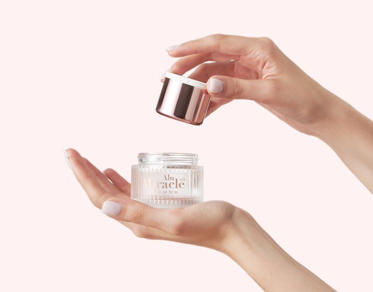 Miracle Alu Refill 50 ml glass jar by Berlin Packaging Beauty being refilled with removable cup held by hands, illustrating reusable skincare packaging and sustainable refill solution.