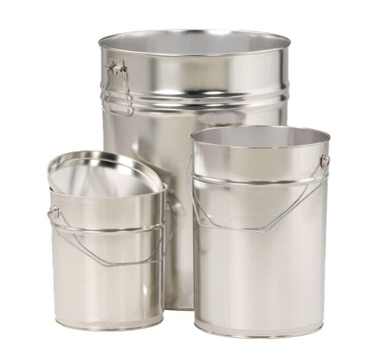 Three various sized pills on a white background, one with an open lid