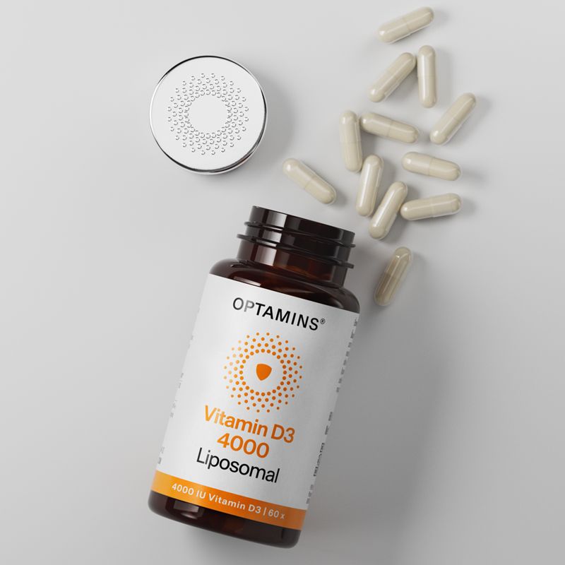 Bottle of Optamins Vitamin D3 4000 IU liposomal capsules with an open cap and several capsules scattered beside it.