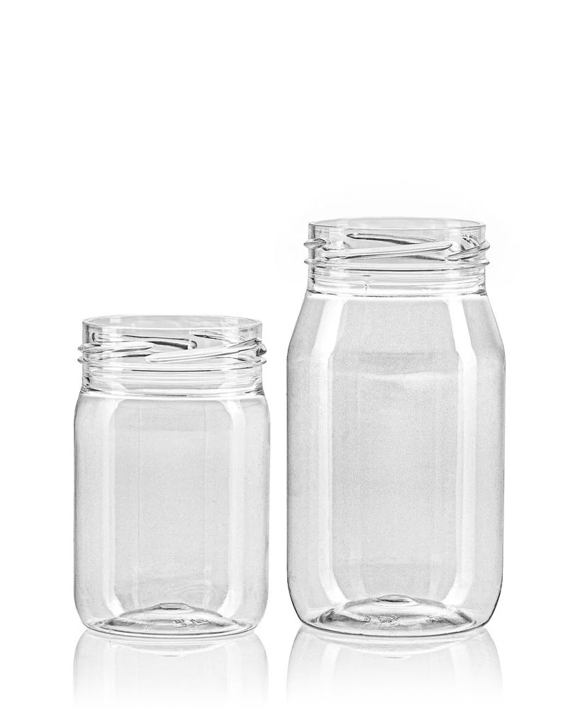 Two clear, empty plastic jars of different sizes with screw-top lids, placed side by side against a white background.