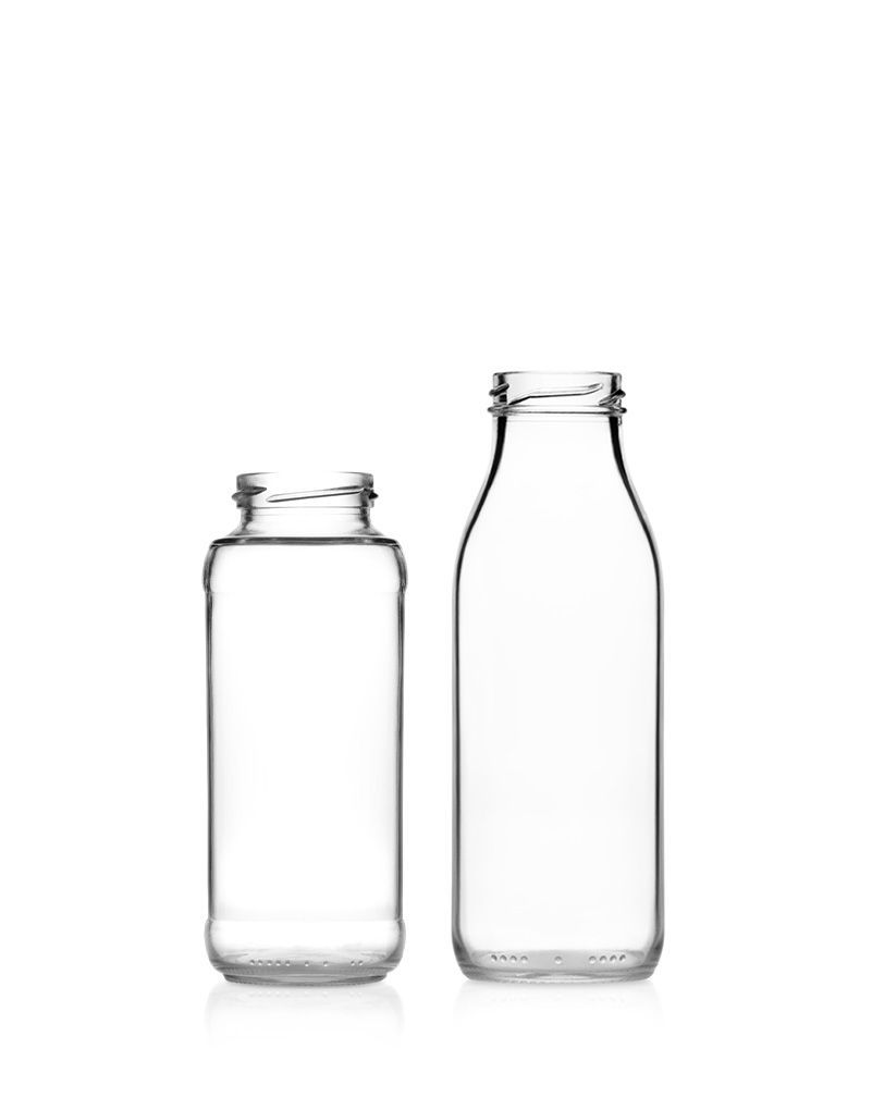 Two clear, empty glass bottles of different heights stand side by side against a plain white background.