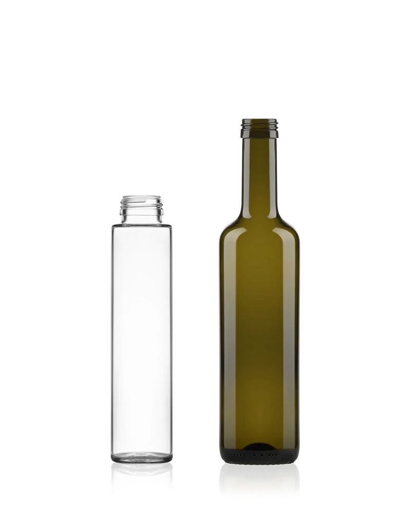 Two tall bottles, one clear and open, the other green with a closed neck, stand side by side on a plain white background.