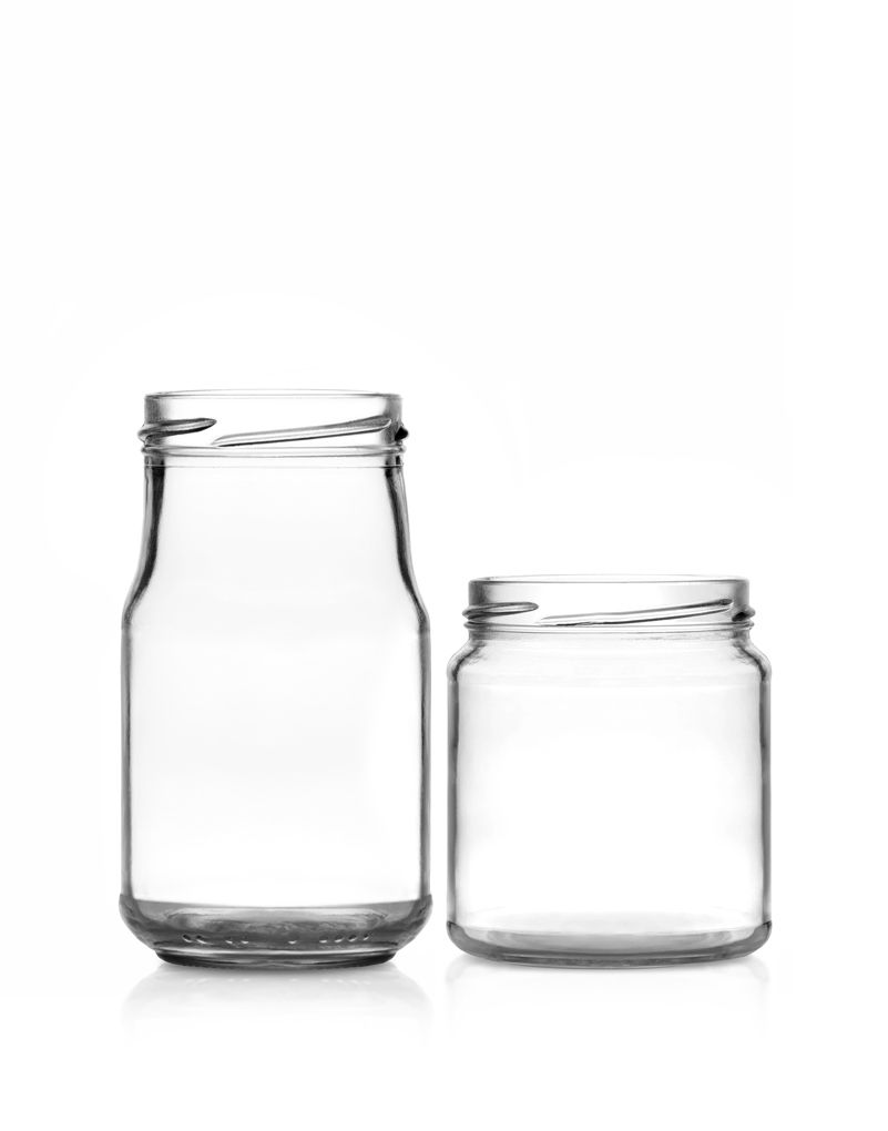 Two empty glass jars on a white background; one tall and narrow, the other short and wide.