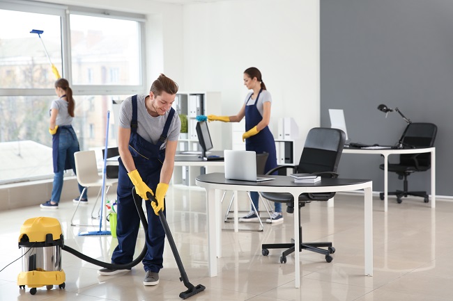 A group of people in a room with cleaning equipment