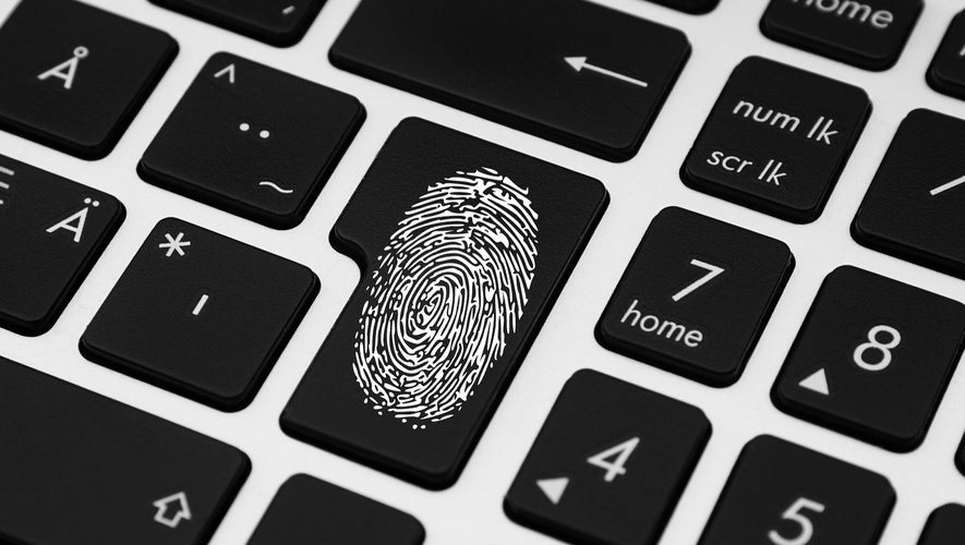 Close-up of a keyboard with a fingerprint symbol on the enter key, surrounded by black keys with white symbols and letters.