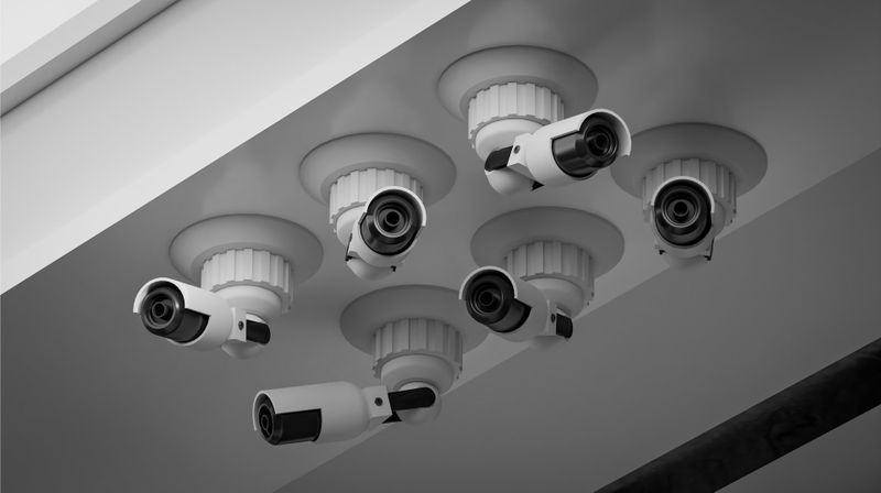 Six security cameras mounted on a ceiling, grouped in a hexagonal formation, with a modern design.