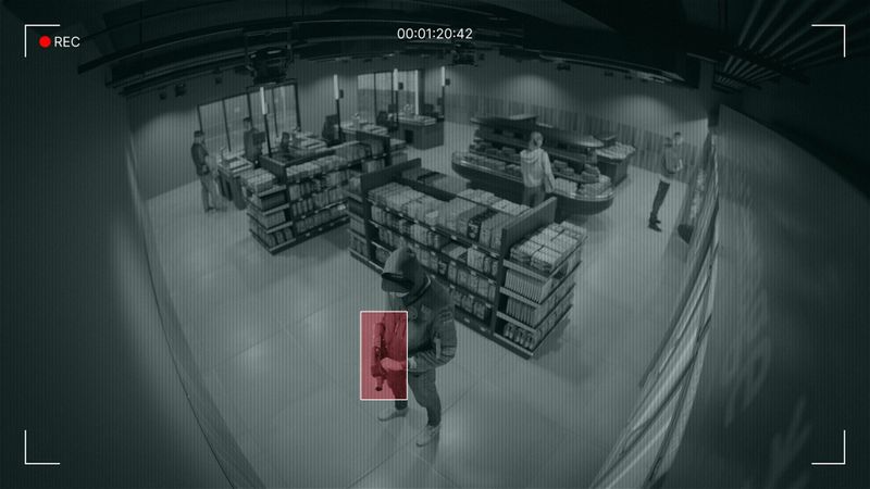 foto de vigilancia de la tienda con el arma que sostiene el hombre marcada en rojo
