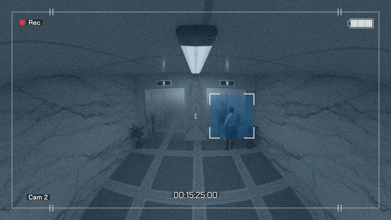Surveillance footage of a man standing near an elevator in a lobby with marble walls and floor, timestamped and marked by a camera overlay.