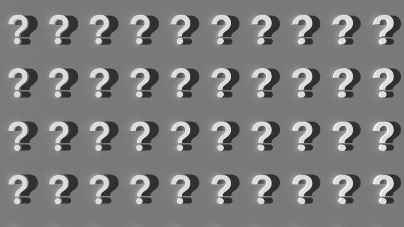 A grid of gray 3D question marks on a gray background, evenly spaced in five rows.