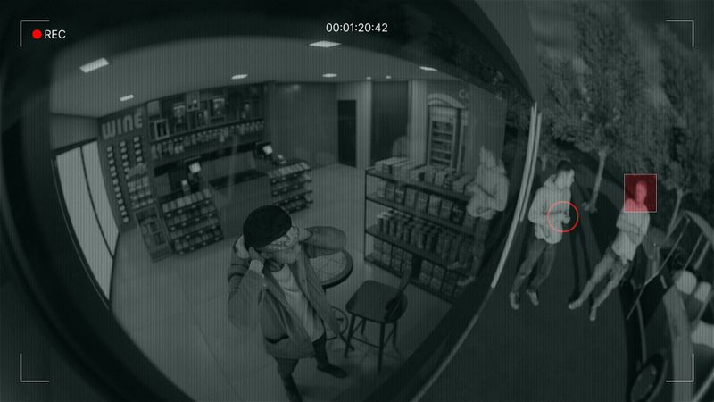 Security camera footage showing a person inside a store holding a phone, with two people and a highlighted figure outside.