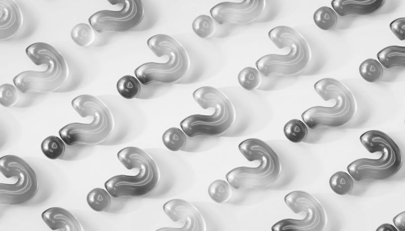 Abstract pattern with 3D question mark shapes in grayscale, arranged in a repeating diagonal grid on a white background.