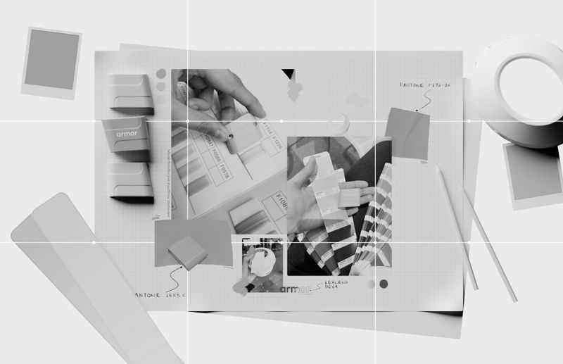 A black-and-white collage showing hands selecting paint samples, along with notebooks, tape, and sketch elements spread out on a table.