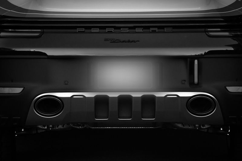 photo of the rear of a Porsche sports car with a blurred license plate