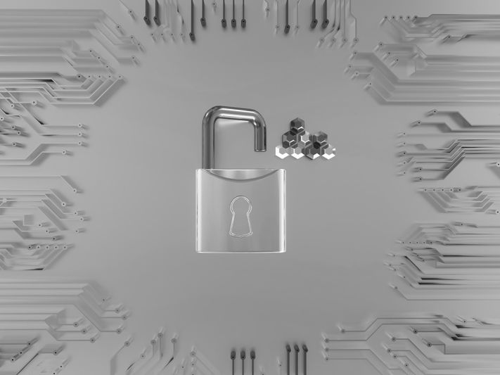 A silver padlock with a keyhole is surrounded by circuit patterns and hexagonal shapes on a gray background, symbolizing cybersecurity.