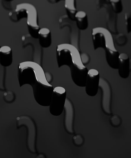 Floating glossy black question marks against a dark background, casting subtle reflections and shadows.
