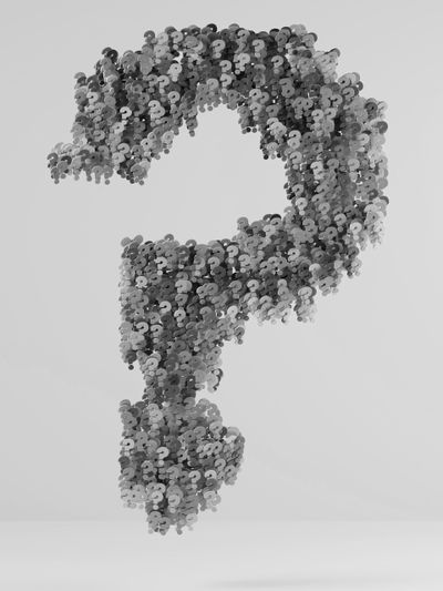 A large question mark made of numerous small, black and white question marks, floating against a light gray background.