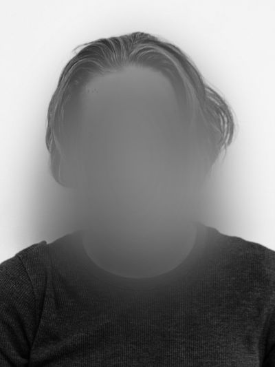 black and white selfie portrait of a man with an anonymized face
