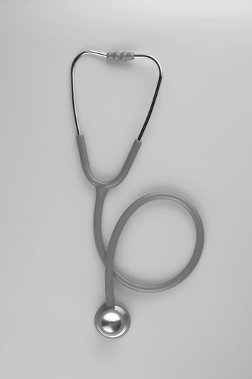 A grey stethoscope with coiled tubing on a light background, showing the chestpiece and earpieces.
