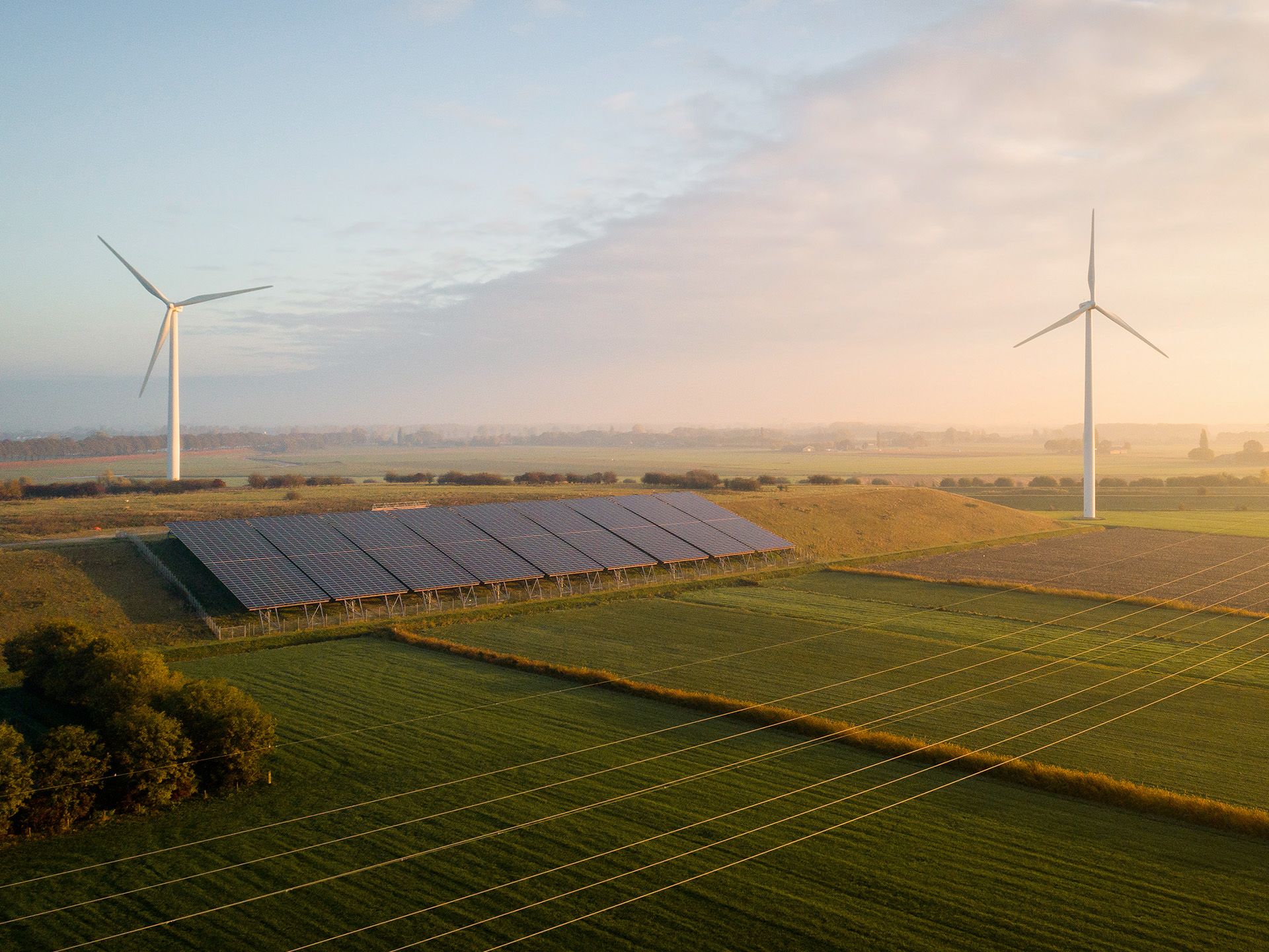 PV Anlage steht auf Feld im Hintergrund Windraeder