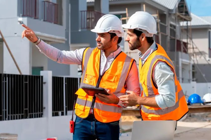 2 men with hardhats on construction site