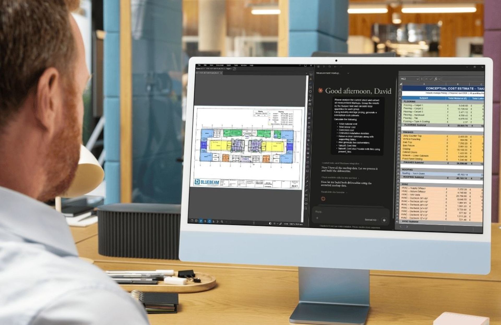Man viewing architectural plans, notes, and cost estimates on a computer screen in an office setting.
