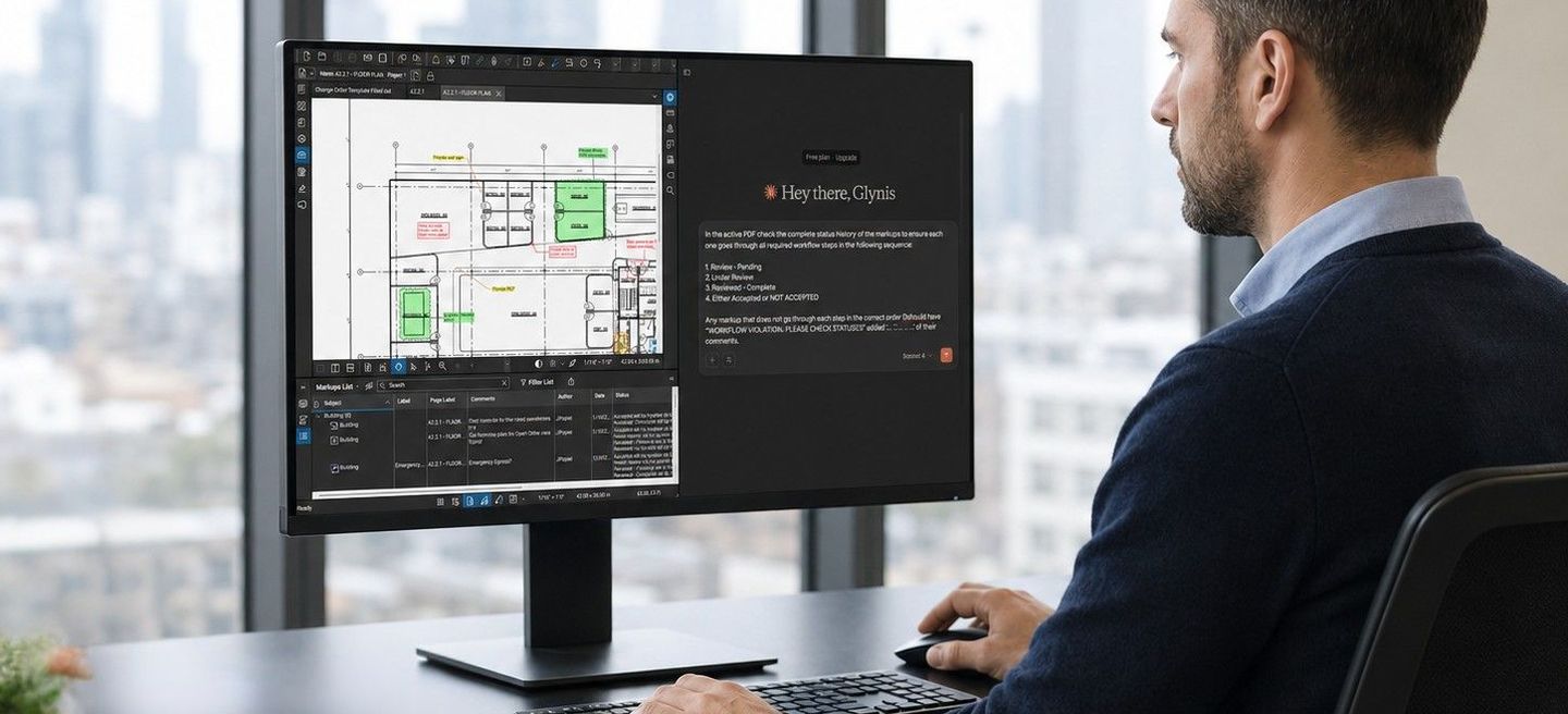 A man working on architectural plans and text on a large monitor in a modern office with a city skyline view.