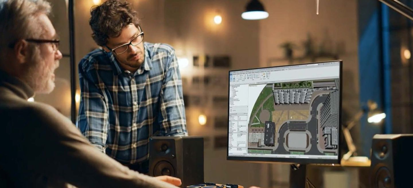 Two men looking at a building design project on a computer screen