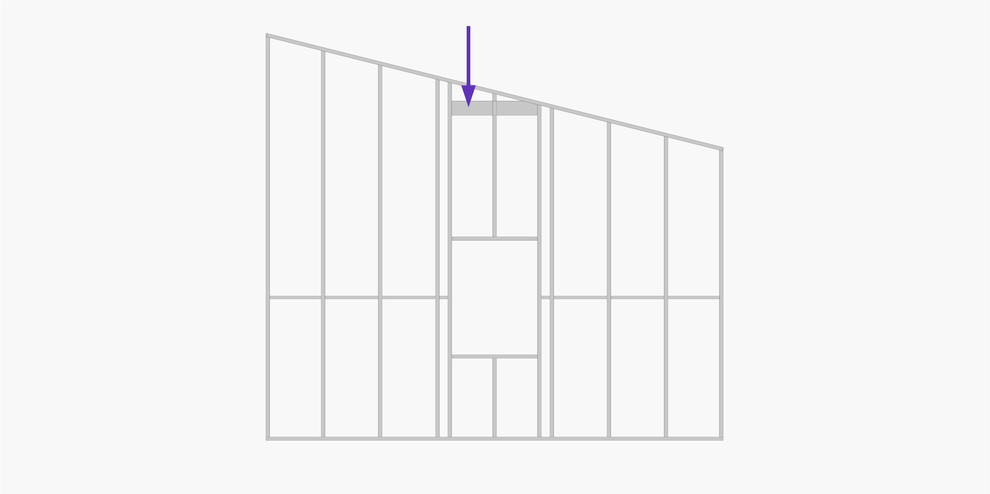 Metal wall frame that has a sloped top and an opening for a window