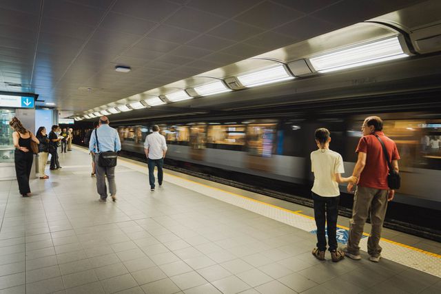 Passengers wait on a STIB-MIVB metro platform in Brussels as a train arrives at the station.