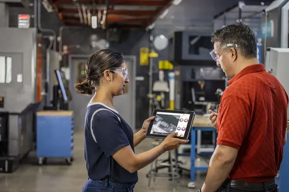 Factory engineers participate in onboarding and skills training using Autodesk software on the production floor, supporting continuous learning as engineering tools evolve.