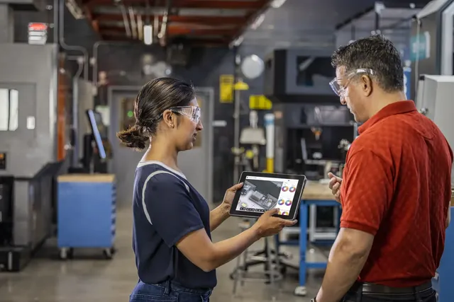 Factory engineers participate in onboarding and skills training using Autodesk software on the production floor, supporting continuous learning as engineering tools evolve.