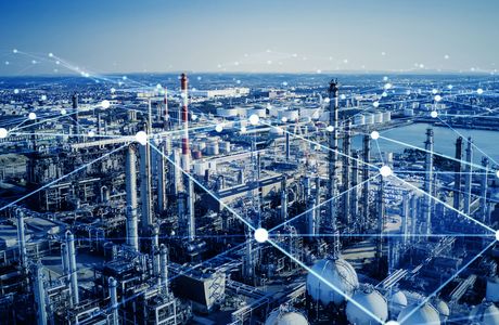 Industrial landscape with factories, smokestacks, and network lines overlay, symbolizing connectivity and technology integration.