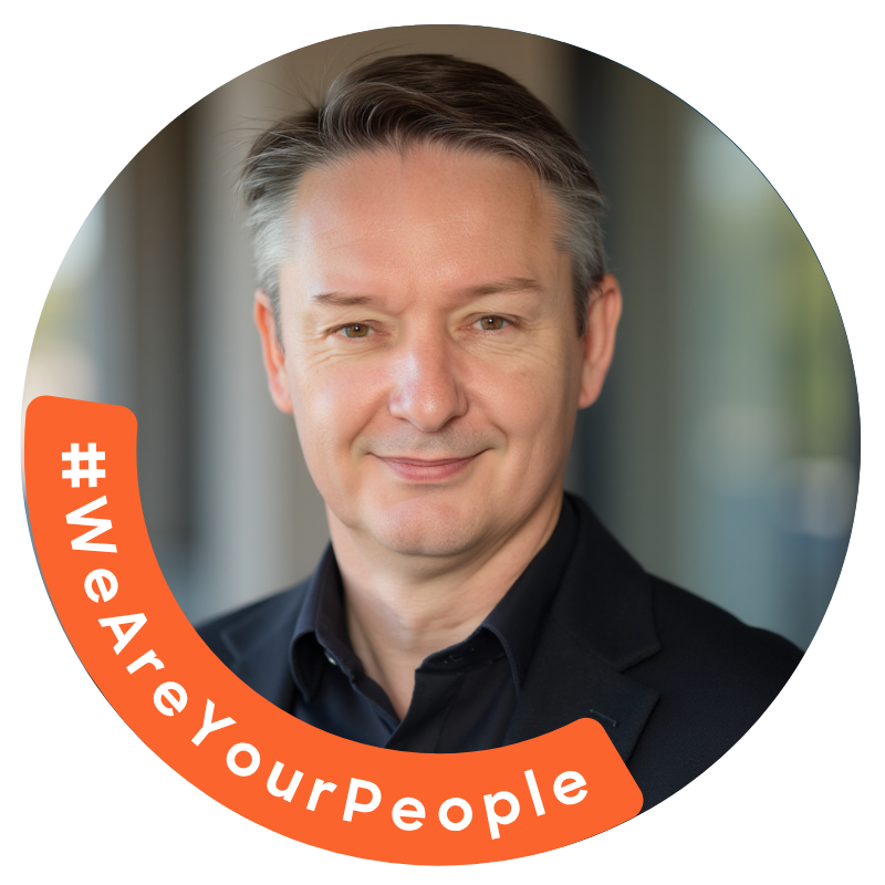 Smiling man in a suit, circular frame with "#WeAreYourPeople" on an orange banner.