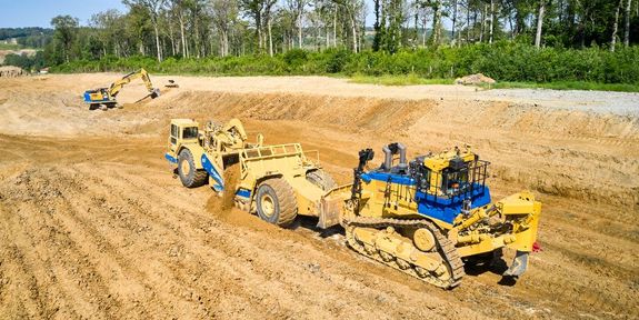 Earthmovers, excavators, and bulldozers working on site