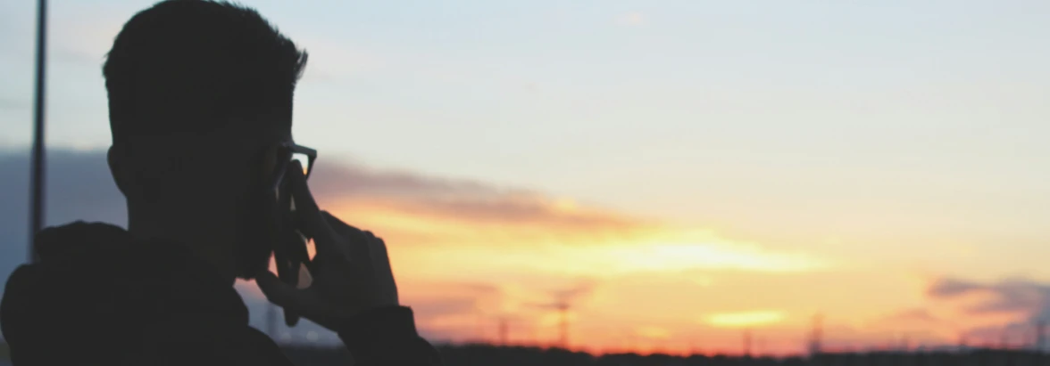 Top 5 Enterprise Trends 2026 - a man talking on a phone overlooking a sunset