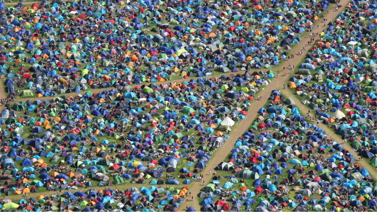 Aerial view of tents at a music festival, illustrating the scale of festival IoT connectivity