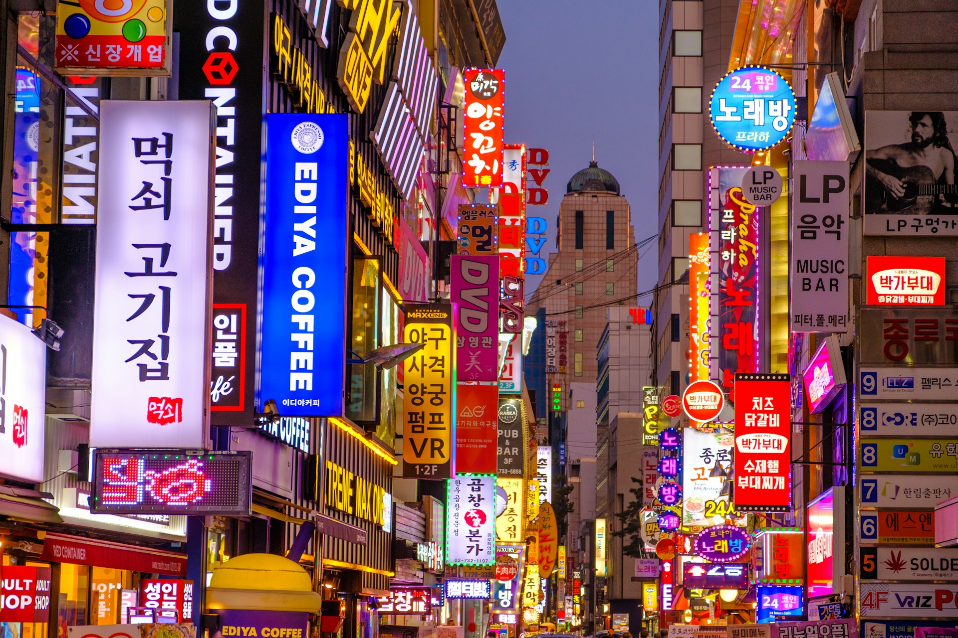 A street scene showing neon-lit signs in Seoul, South Korea
