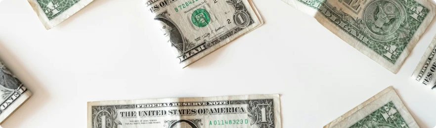 A Risk-Based Future - US One Dollar bills arranged on a white surface