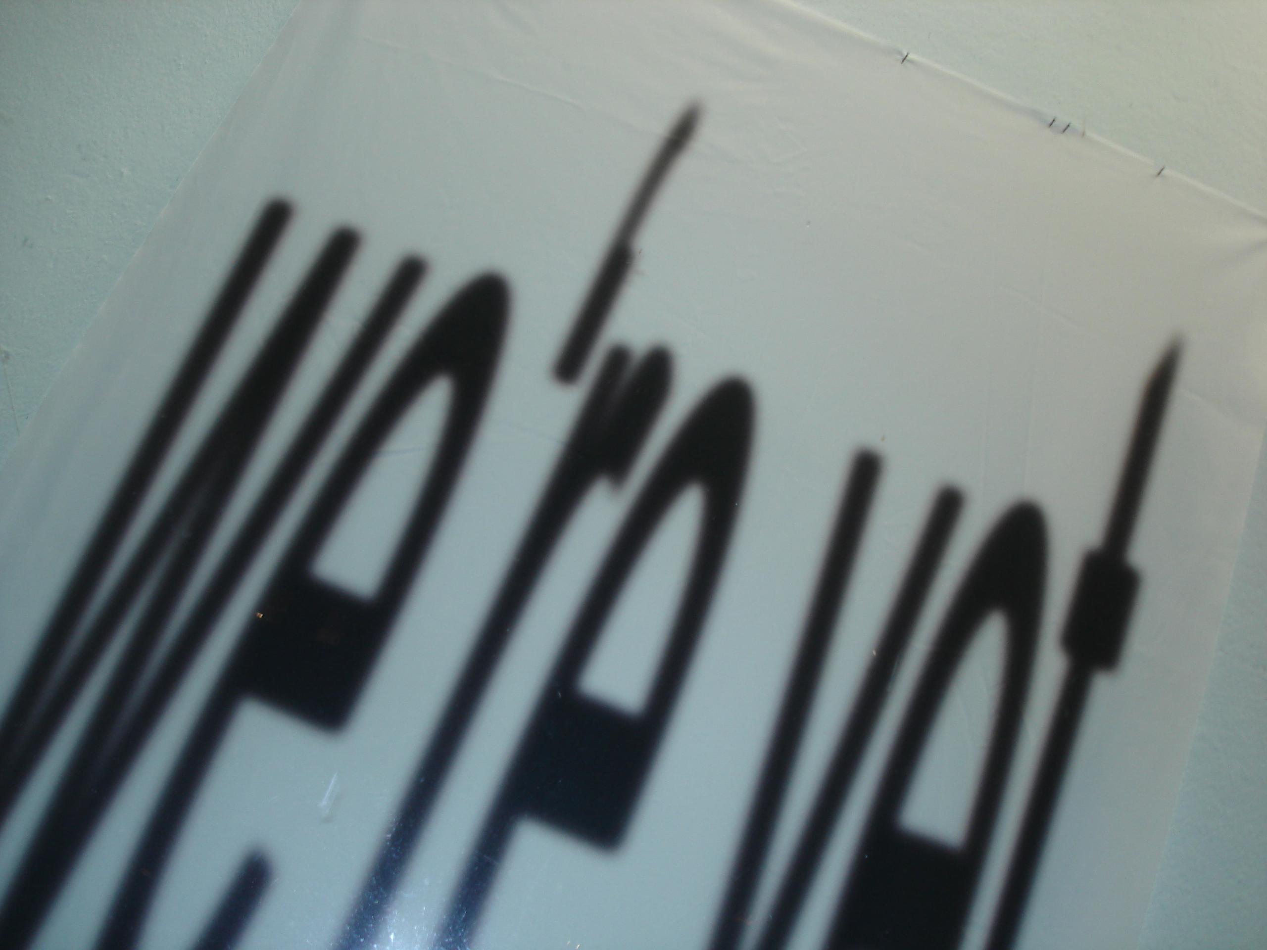 Blurred text on a white background, partially readable as "We're not," with a distorted, shadowy appearance.
