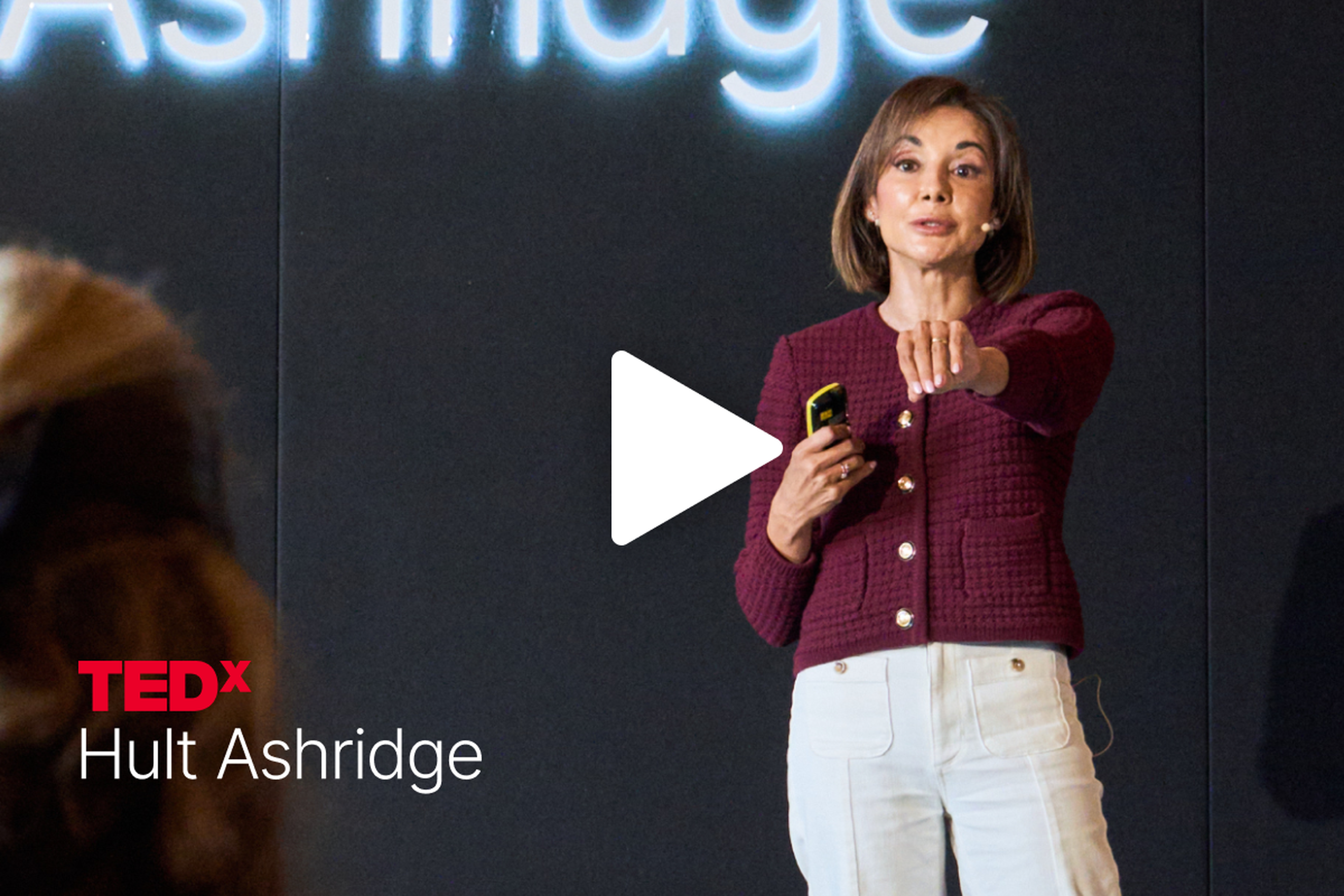 Sona Sherratt speaks on stage at TEDx Hult Ashridge