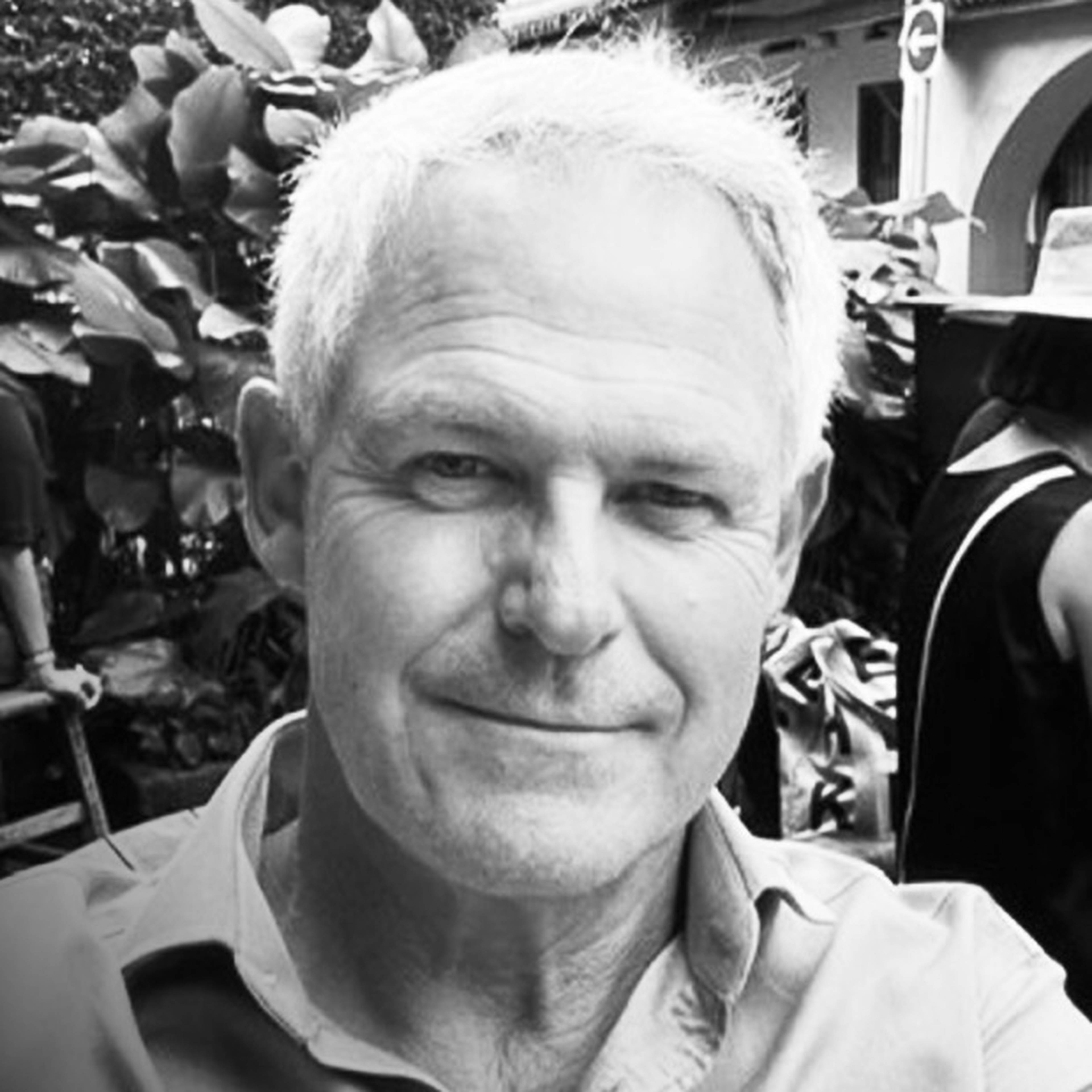 Headshot of Dr David Briggs in black and white