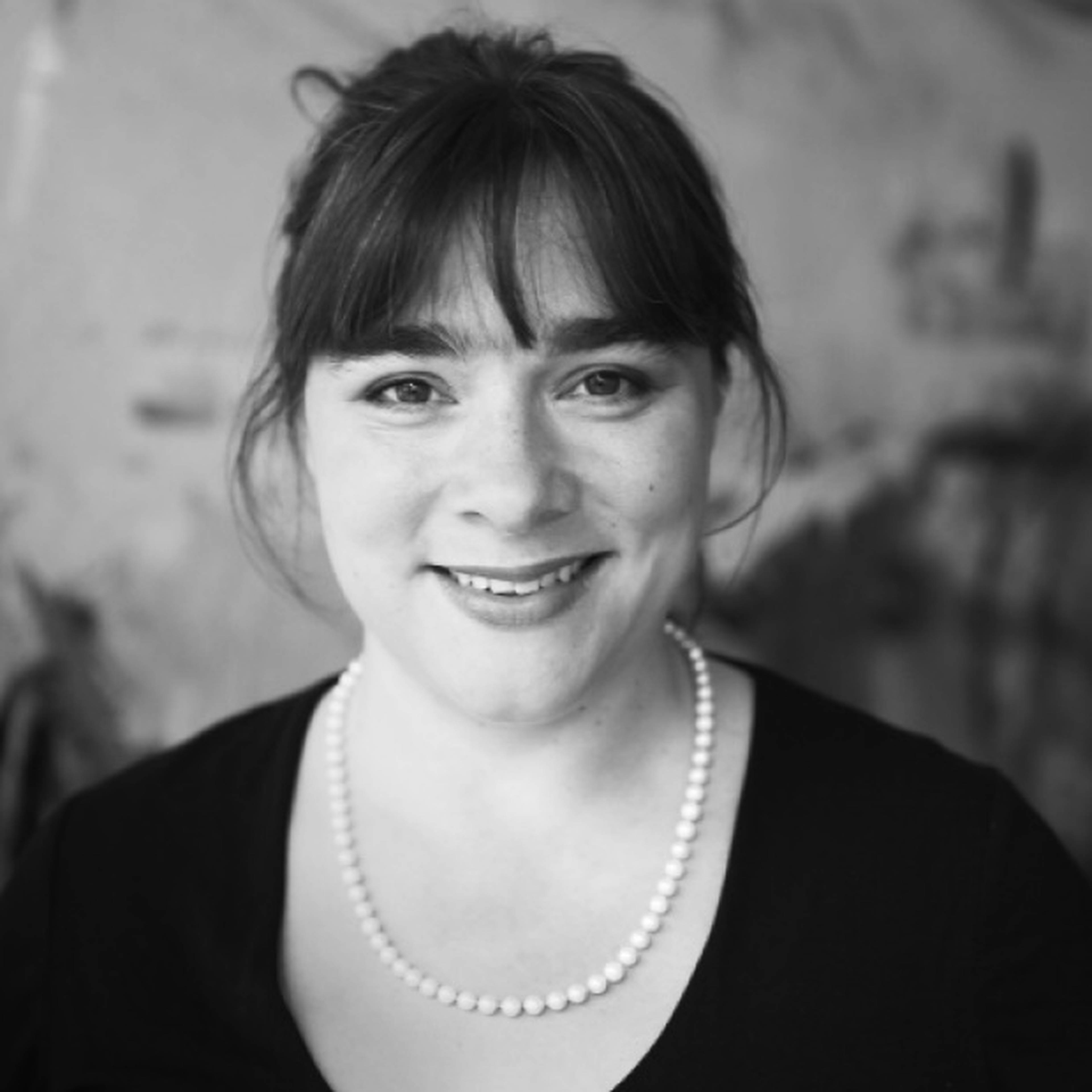 Headshot of Eve Poole in black and white