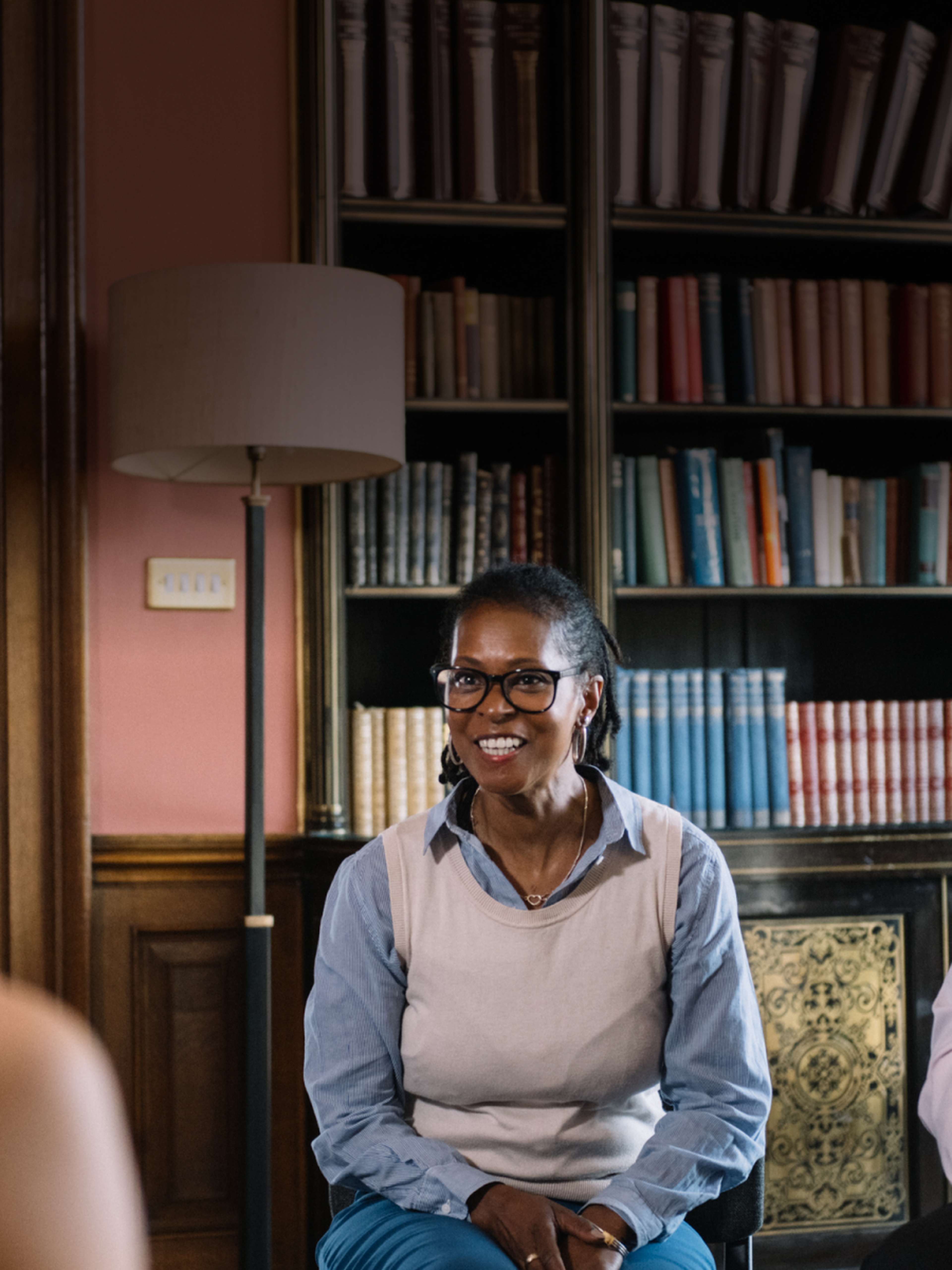 Woman in leadership sitting in a room with bookshelves