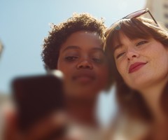 Two young women looking at a mobile phone
