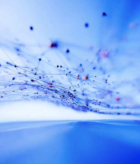 Astronaut in shiny silver suit and pink boots stands on wet ground, with a blue sky and palm trees in the background.
