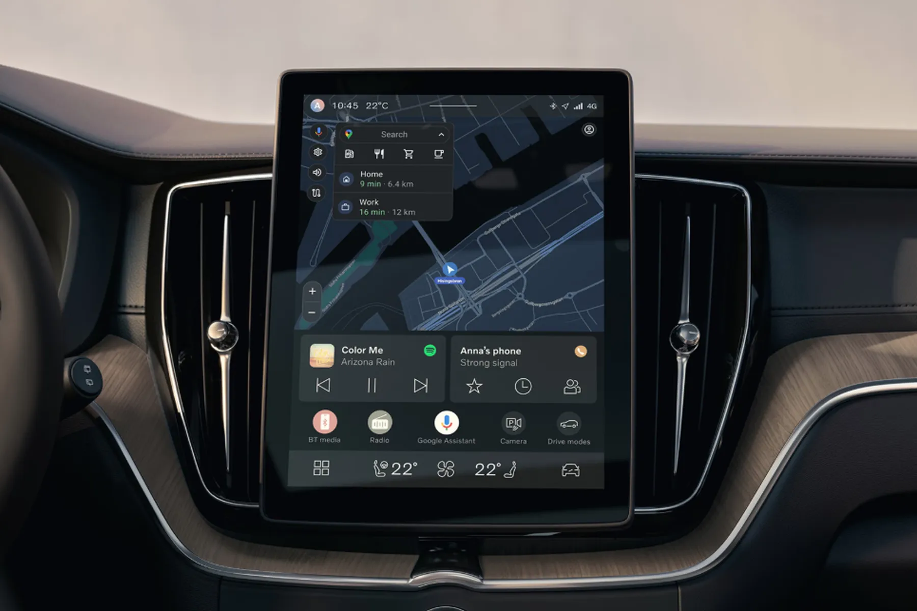 Car dashboard with a central touchscreen displaying GPS navigation, music controls, and various app icons in a sleek, modern interior.