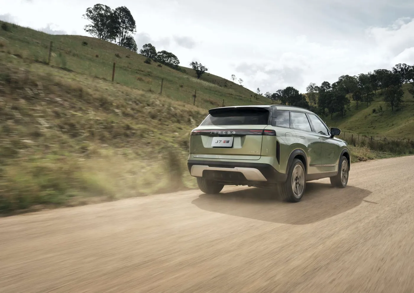 Jaecoo J7 SHS-P Track SUV driving on a country road, rear view