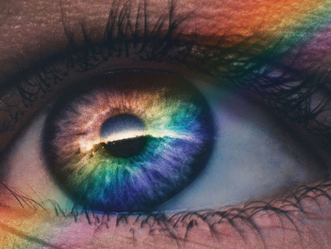 Photo of an eye overlaid with a colourful rainbow