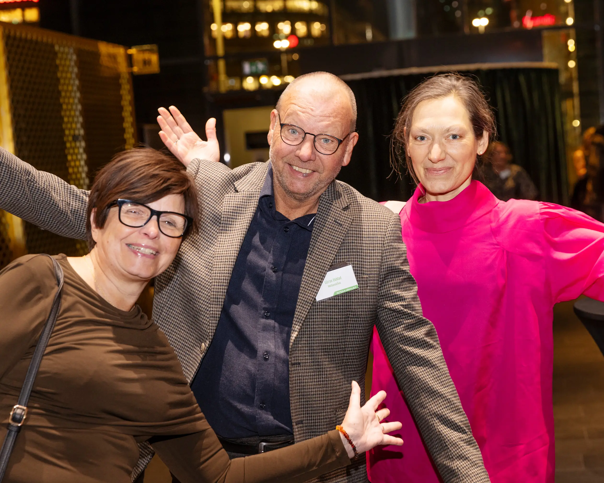 Tre glada personer på fest