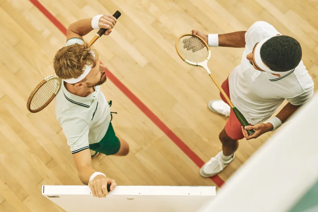 Zwei Männer unterhalten sich über Squash und planen die nächste Session mit Evesports zu buchen